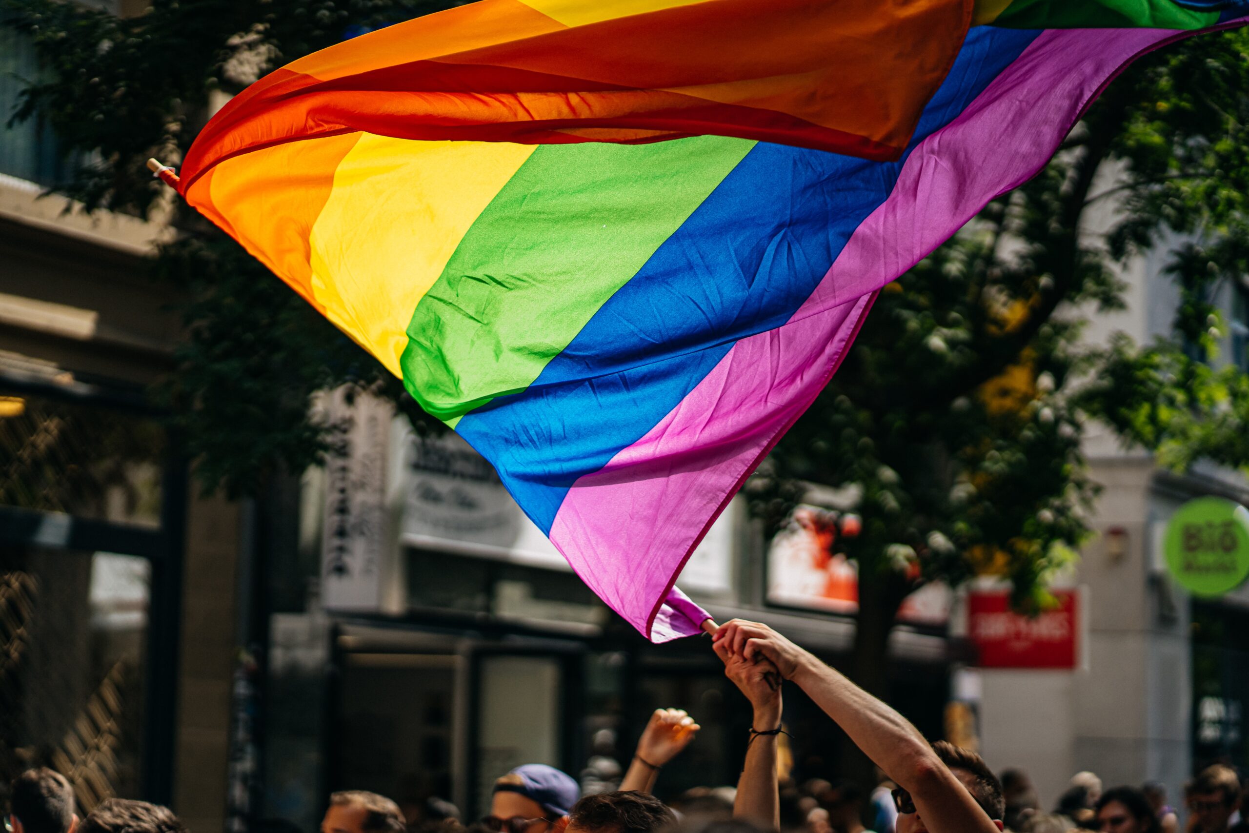 A person waves a pride flag